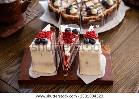 strawberry chesse cake with fresh blue berry on wooden tray