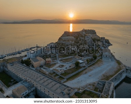 Aerial drone view of beautiful corfu town with old fortress in background in sunrise, Kerkyra, Greece