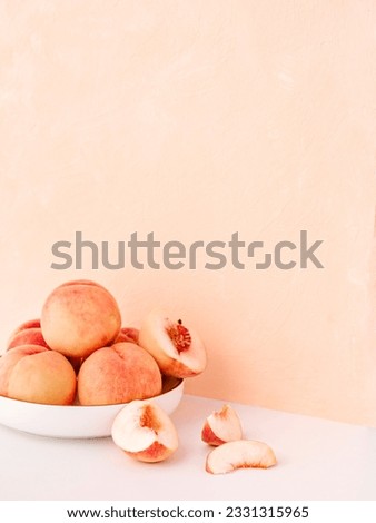 Summer fruit background. Composition with pale pink tender peaches. Ripe fresh organic fruit, vegan food. Harvest concept. Fruity summer diet concept. Copy space for text. Royalty-Free Stock Photo #2331315965