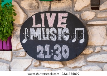 Live music sign on the bar wall.