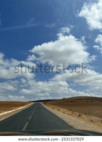 On our way to the farm take a picture of the street with big clouds and blue sky