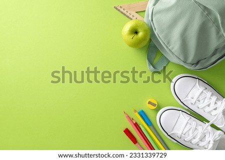An eye-catching image of a backpack, sneakers and stationery viewed from above on a light green isolated background. Suitable for educational marketing materials and text placement