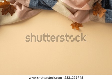 Feel the comfort of being at home in fall season with this high angle view photo of warm patchy blanket with maple leaves and empty space offering place for text or advert on beige isolated background