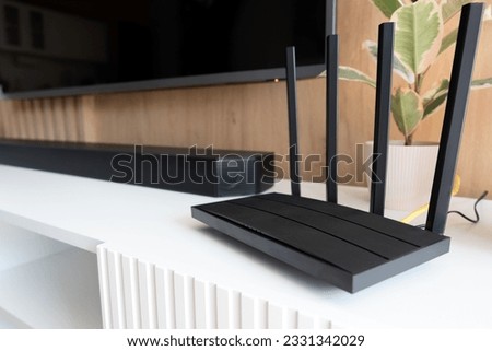 Router with 4 antennas in living room. High speed internet concept Royalty-Free Stock Photo #2331342029