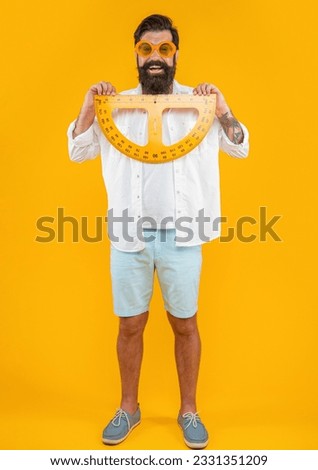 positive man hold geometry protractor isolated on yellow. man hold geometry protractor
