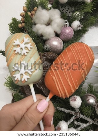 Two ice cream cake pops on the background of a Christmas wreath