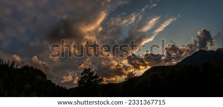 Sunset top panorama shot with dramatic clouds in summer
