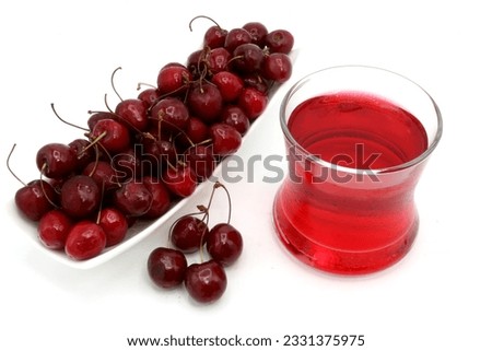 fresh charry juice og glass fresh red cherries fruit in dish isolated on white background