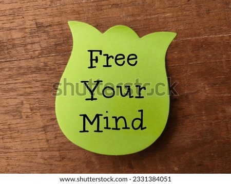 Colored sticky note with the word FIND YOUR MIND on a wooden background