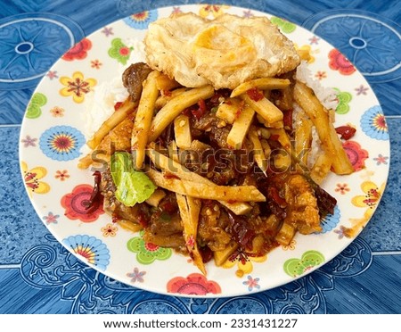 a photography of plate of food with a sandwich and french fries.
