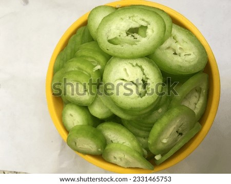 A close up of a slices Snake or cut snake gourd ready to cook. Royalty-Free Stock Photo #2331465753