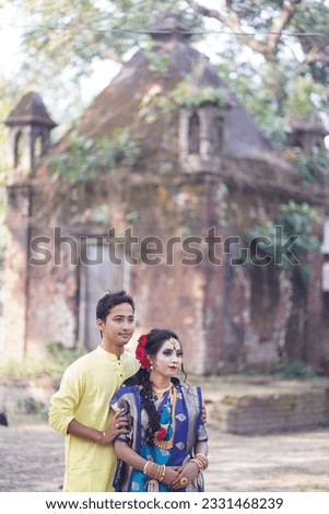 A couple is doing a photo shoot in front of an old temple