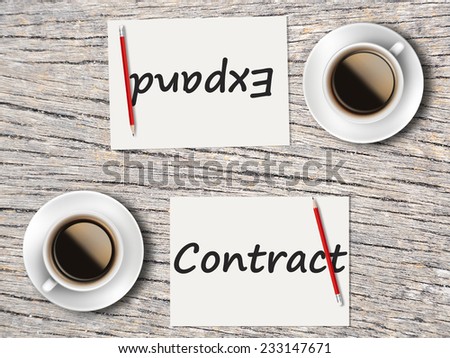 Business Concept (Rotatable) : Two Coffee, Papers And Pencils On The Table  Facing Each Other Head To Head To Compare Between Contract And Expand.