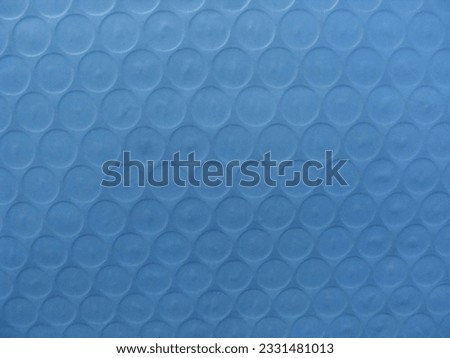 Several small circles on a light blue background.