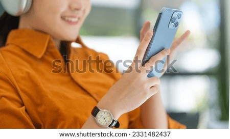 Young woman surfing social media or texting messages on mobile phone. Communication, technology and lifestyle concept.