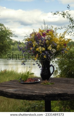 Splendid bouquet of wild flowers on landscape background