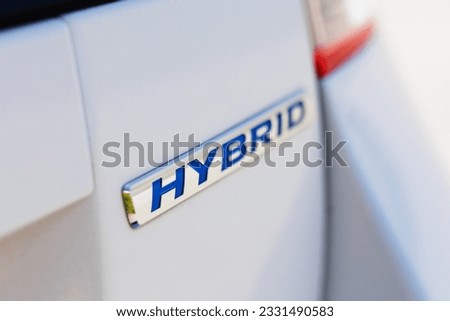 Close up view of a hybrid car logo Royalty-Free Stock Photo #2331490583