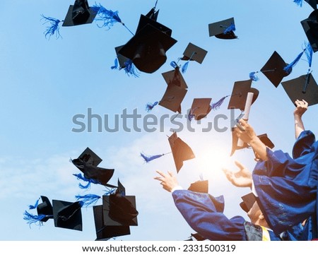 Graduating students hands throwing graduation caps in the air. Royalty-Free Stock Photo #2331500319