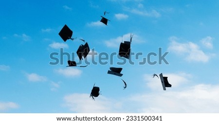 Group of graduation caps thrown in the air.
