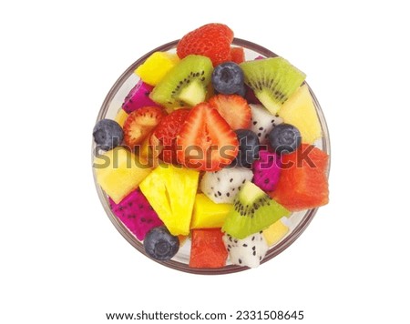 Bowl with colorful fruit salad isolated on white background, top view.