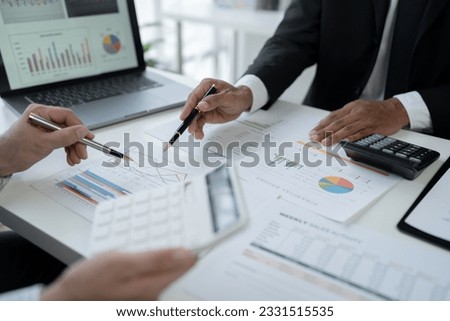 team work process Business team use calculator to calculate figures, business statistics, profit, cost analysis, growth rate graph document. data charts on the desk