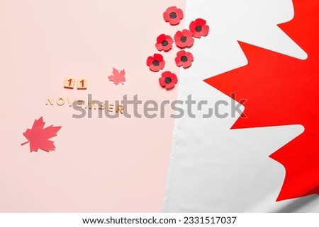 Poppy flowers with flag of Canada and text 11 NOVEMBER on pink background. Remembrance Day