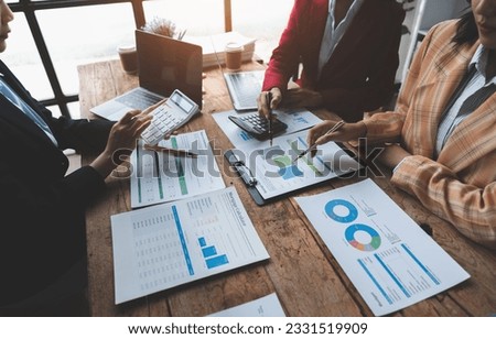 Businesswoman teamwork discussing brainstorming and calculating with calculator on evaluation data in conference room Focus on business growth and point out financial accounting charts.
