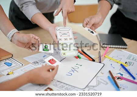 Close-up image of a mobile application developer team is in the meeting, planning and brainstorming on a new mobile app together. UI, UX, mobile application, tech startup Royalty-Free Stock Photo #2331520719