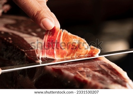 iberian ham is a gourmet product made from the meat of free-range acorn-fed iberian pigs. it is famous for its intense and aromatic flavour, and is usually served as an appetizer or tapa. Royalty-Free Stock Photo #2331530207