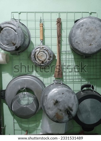 traditional cookware hanging in the kitchen  Royalty-Free Stock Photo #2331531489