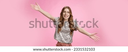 Come into my arms. Portrait friendly outgoing charming cute caucasian female wearing glittering blouse extend arms sideways wanna embrace cuddle friend welcoming hugging guests, smiling broadly.