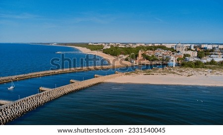 Drone view in the sunny day of lighthouse and harbor in Kolobrzeg, Poland.