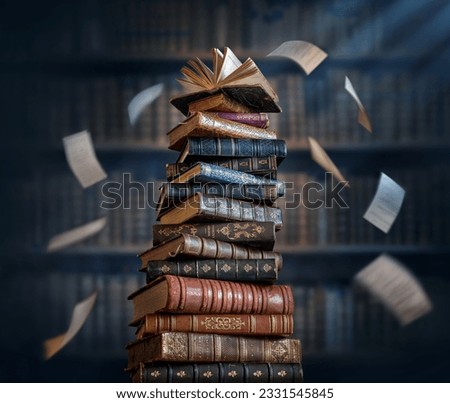 A stack of old books and flying book pages against the background of the shelves in the library. Ancient books historical background. Conceptual background on history, education, literature topics.