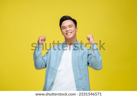 Cheerful happy young man posing isolated on bright yellow background Royalty-Free Stock Photo #2331546571