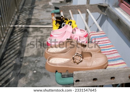 Family sandals of various sizes are soaked in the sun