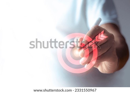 The man pressed the arrow on the target's image. The concept of achieving goals in life goal setting. with copy space Royalty-Free Stock Photo #2331550967