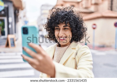 Young middle east woman excutive smiling confident make selfie by smartphone at street