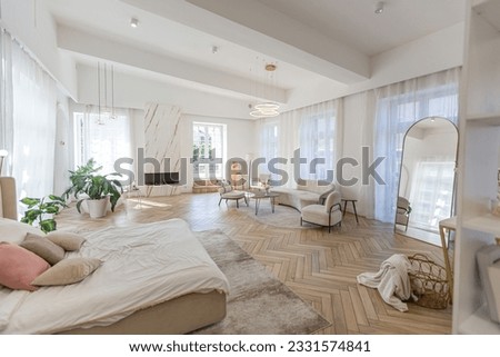 spacious open-plan apartment with stylish modern bright design, dressing area, bedroom, living room and bathroom on a sunny day Royalty-Free Stock Photo #2331574841