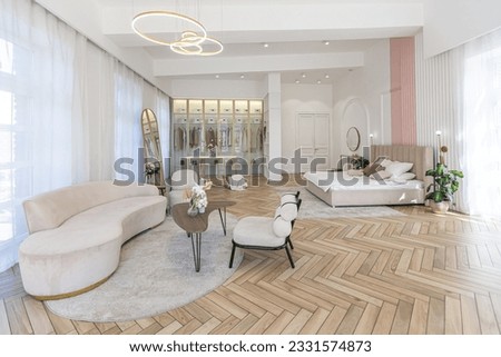 spacious open-plan apartment with stylish modern bright design, dressing area, bedroom, living room and bathroom on a sunny day Royalty-Free Stock Photo #2331574873