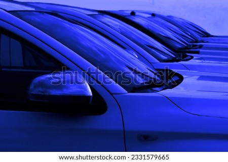 blue SUV cars standing in a row. Fleet of generic modern cars. Transportation. Luxury OFFROAD car fleet consisting of generic brandless design. isolated on black background Royalty-Free Stock Photo #2331579665