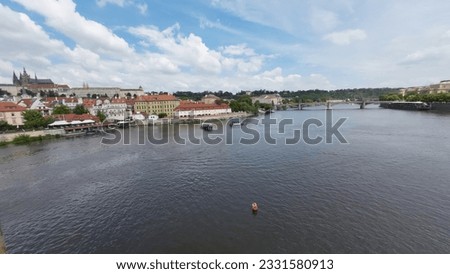 Boats on the Vltava River, view from Charles Bridge, in Prague city, Czech Republic