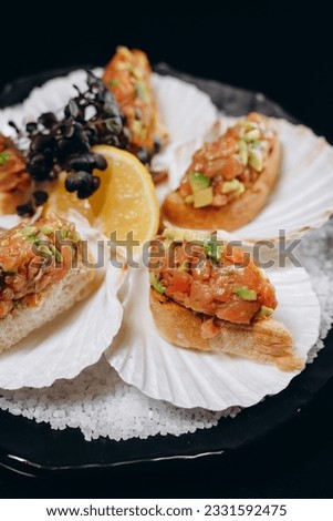 Cold fish appetizer Salmon and avocado tartar in shells