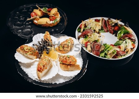 Presentation of three dishes tartar, bruschetta and salad