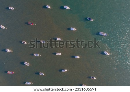 zenithal aerial view of small fishing boats moored on the shore