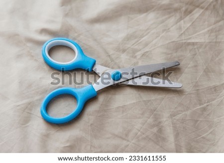 Metal office scissors with blue finger holders