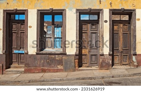 Street below the Naval Academy;  Valpari; Bass relief houses;  Cafe sign; Doorways; Graffito; Grey doorway; Street bivouac; Tangles; Window on a cat's world; Valpariso, Chile Royalty-Free Stock Photo #2331626919