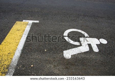 Wheelchair Handicap Sign on dark asphalt road street background- handicap parking place