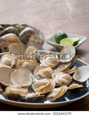 Sake-steamed clams from JapanMade in Japan, clams, steamed in sake, Japanese food, made in Kuwana Royalty-Free Stock Photo #2331641579