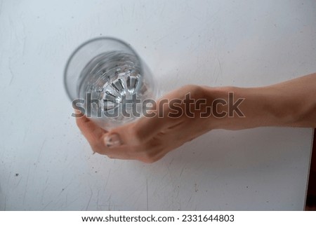 women's hands computer phone glass of water in their hands