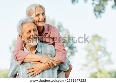 Happy active senior couple having fun outdoors. Portrait of an elderly couple together Royalty-Free Stock Photo #2331647225